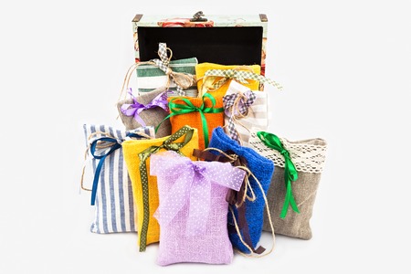 Decorative textile sachet pouches with gift box on white backgroundの写真素材