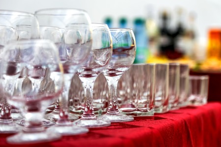 Empty wine glasses composition on table before celebration at outdoorの写真素材