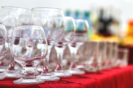 Empty wine glasses composition on table before celebration at outdoorの写真素材