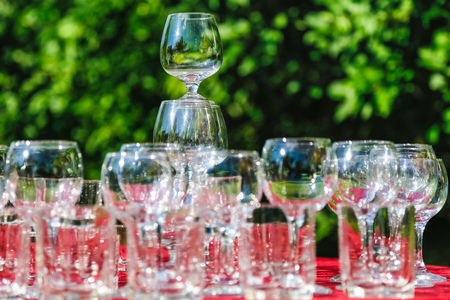 Empty wine glasses composition on table before celebration at outdoorの写真素材