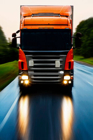 Truck delivery cargo on the highway in motionの写真素材