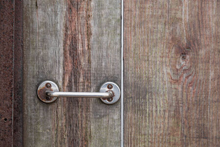 Metal rusty door handle on wood backgroundの写真素材