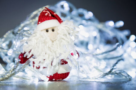 Santa Claus or Father Frost with Christmas lights at background on silver or metal grunge surfaceの写真素材