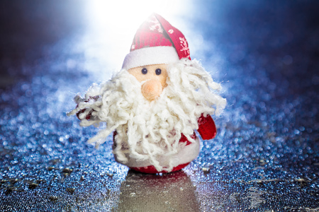 Christmas Santa Claus or Father Frost on silver or metal grunge surface with backlight from behindの写真素材