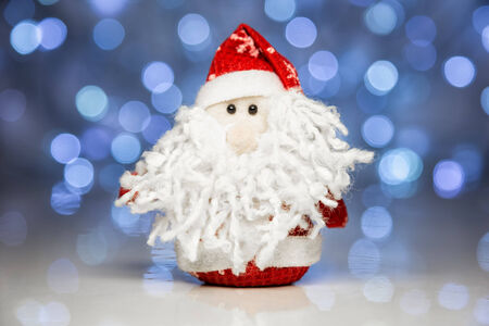 Santa Claus or Father Frost with Christmas lights at background on white surfaceの写真素材