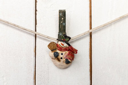 Christmas snowman clothespin hanging on clothesline or rope