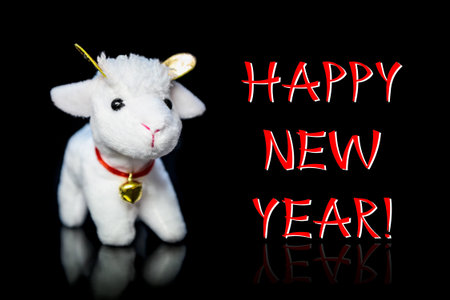 New Year greeting card or postcard with white goat or sheep toy the chinese symbol of 2015 year on...