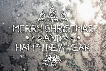 Merry Christmas and New Year hand drawing greeting card on blurred frozen winter silver or gray colored backgroundの写真素材