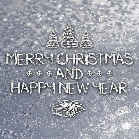 Merry Christmas and New Year hand drawing greeting card on frozen winter silver or gray colored backgroundの写真素材