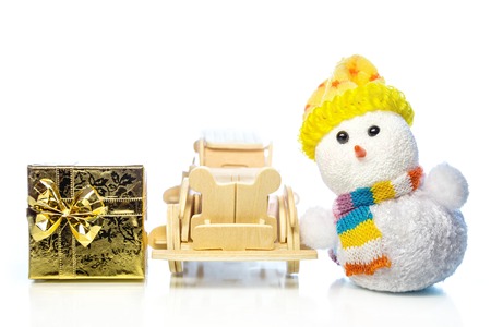 Christmas snowman toy and old vintage wooden automobile with golden or yellow gift box on white background. Main focus of image on Santa Claus and selective on wood carの写真素材