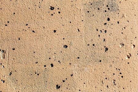 Grunge plaster cement or concrete wall texture yellow colorの写真素材