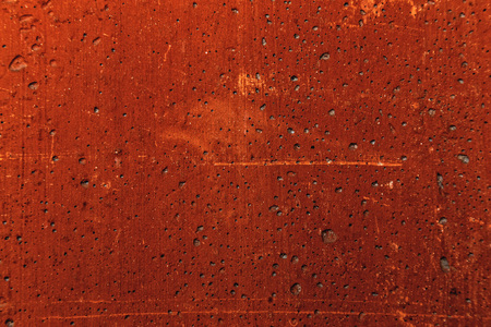Grunge plaster cement or concrete wall texture red color with scratchesの写真素材