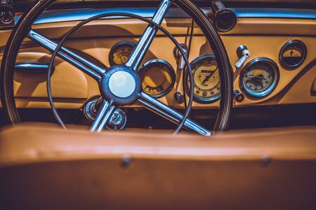 Steering wheel and dashboard in interior of old retro automobile. Processed by vintage or retro effect filterの写真素材