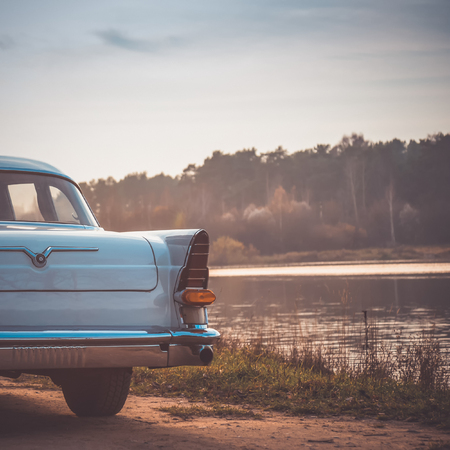Old retro or vintage car or automobile back side with back light or taillight. Processed by vintage or retro effect filterの写真素材