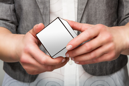 Woman or female hands holding white cubeの写真素材