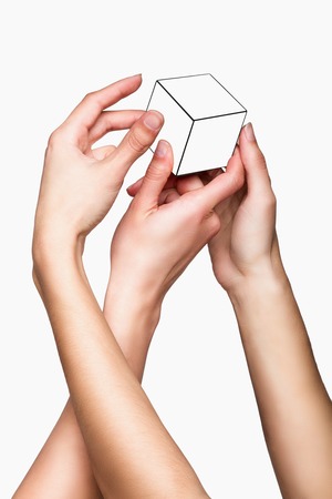 Hands holding white cube on white backgroundの写真素材