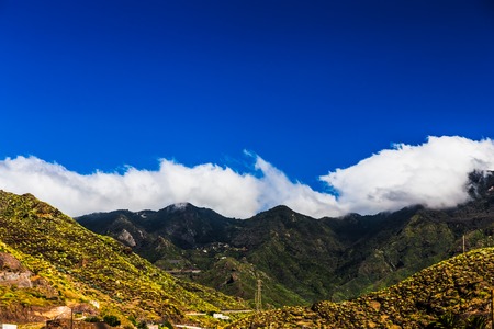 Mountain and clouds on blue sky backgroundの写真素材