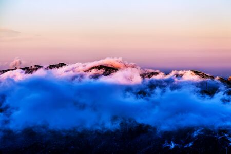 Landscape with pink clouds over mountain and sky horizon in Tenerife island, Spain at sunsetの写真素材