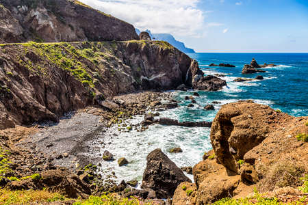 Coast or shore of Atlantic ocean with  mountain or rock and blue sky with clouds and horizon in Tenerife Canary island, Spain at spring or summerの写真素材