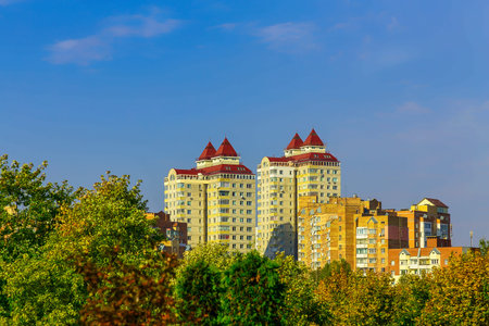 City Buildings in Trees with Yellow and Green Leavesの写真素材