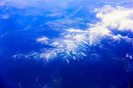 Mountains Aerial View with Snow on Top from Airplaneの写真素材