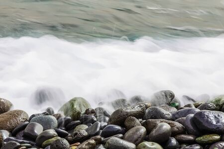 Stone Coast of Ocean with Silky Waves and Foam from long exposure on Tenerife or Canary Island in Spainの写真素材