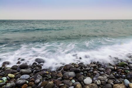 Stone Coast or Shore of Atlantic Ocean with Waves and Foam from long exposure on Tenerife Island in Spainの写真素材