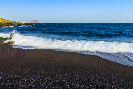 Stone Shore of Atlantic Ocean with Waves and Sky on Tenerife Canary Island in Spain at Dayの写真素材