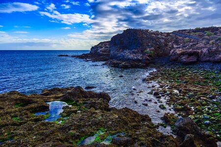 Stone Beach of Atlantic Ocean with Waves on Canary Island in Spain at Dayの写真素材