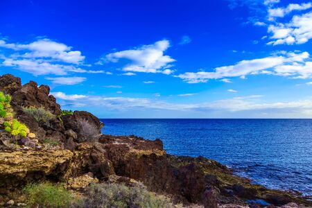 Stone Beach of Atlantic Ocean with Waves and Sky on Canary Island at Dayの写真素材