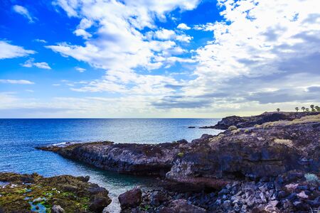 Stone Coast or Shore of Atlantic Ocean with Waves on Tenerife Canary Island at Dayの写真素材