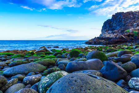 Stone Beach of Ocean with Waves on Canary Island in Spain at Dayの写真素材