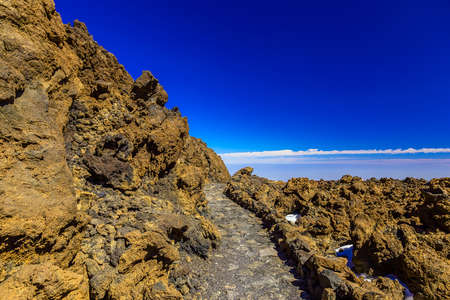 Landscape with pathway in Mountains and Blue Sky on Canary Island in Spain at Dayの写真素材