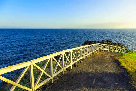Landscape with footpath near Atlantic Ocean Coast and Blue Sky on Tenerife Canary Island in Spain at Dayの写真素材