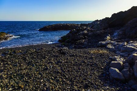 Stone Coast of Atlantic Ocean with Waves and Sky on Tenerife Island in Spain at Dayの写真素材