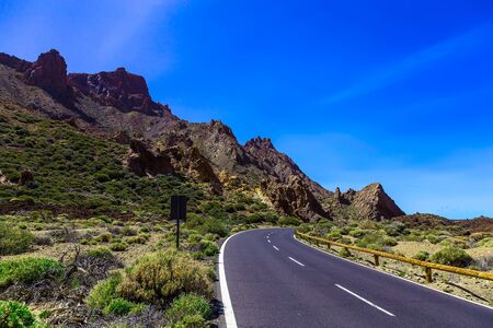 Landscape with Asphalt Road and Mountains with Sky on Canary Island in Spain at Dayの写真素材