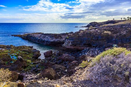 Stone Coast or Shore of Atlantic Ocean with Waves on Canary Island at Dayの写真素材