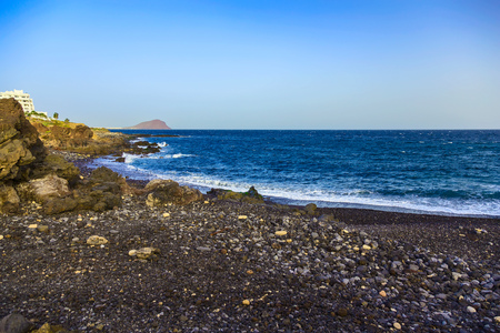Stone Shore of Ocean with Waves on Canary Island in Spain at Dayの写真素材