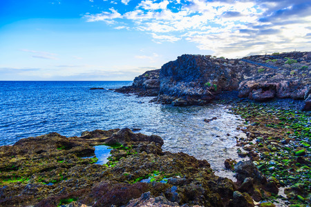 Stone Beach of Ocean with Waves and Sky on Canary Island at Dayの写真素材