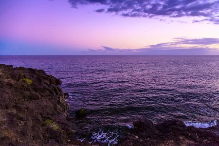 Stone Coast of Atlantic Ocean on Tenerife Island at Eveningの写真素材