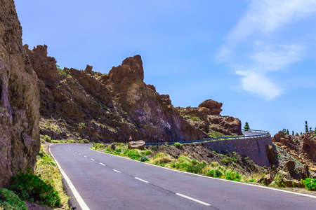 Landscape with Asphalt Road and Mountains with Sky on Canary Island in Spain at Dayの写真素材