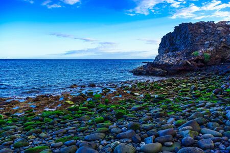 Stone Beach of Ocean with Waves on Tenerife Island at Dayの写真素材