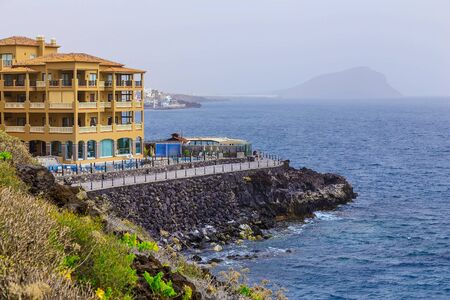 Rock Coast or Shore of Atlantic Ocean with Buildings Seascape on Tenerife Island in Spainのeditorial素材