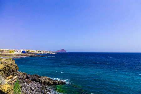 Rock Coast or Shore of Atlantic Ocean with Buildings Landscape on Canary Island in Spainの写真素材