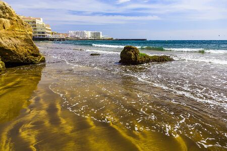 Sand Beach Coast or Shore of Atlantic Ocean with Buildings Landscape on Tenerife Canary Island in Spain at Dayの写真素材
