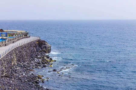 Rock Coast or Shore of Atlantic Ocean with Buildings Seascape on Canary Island in Spain at Dayの写真素材