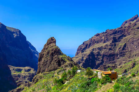 Small Village and Buildings in Green Mountains Landscape on Tenerife Canary Island in Spain at Dayの写真素材