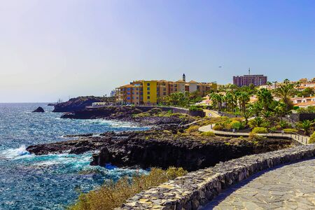 Rock Coast or Shore of Atlantic Ocean with Buildings Landscape on Canary Island at Dayのeditorial素材
