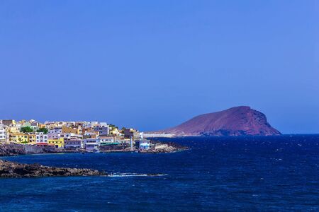 Rock Coast or Shore of Atlantic Ocean with Buildings Landscape on Tenerife Island at Dayのeditorial素材