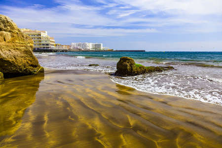 Sand Beach Coast or Shore of Atlantic Ocean with Buildings Landscape on Canary Island at Dayの写真素材